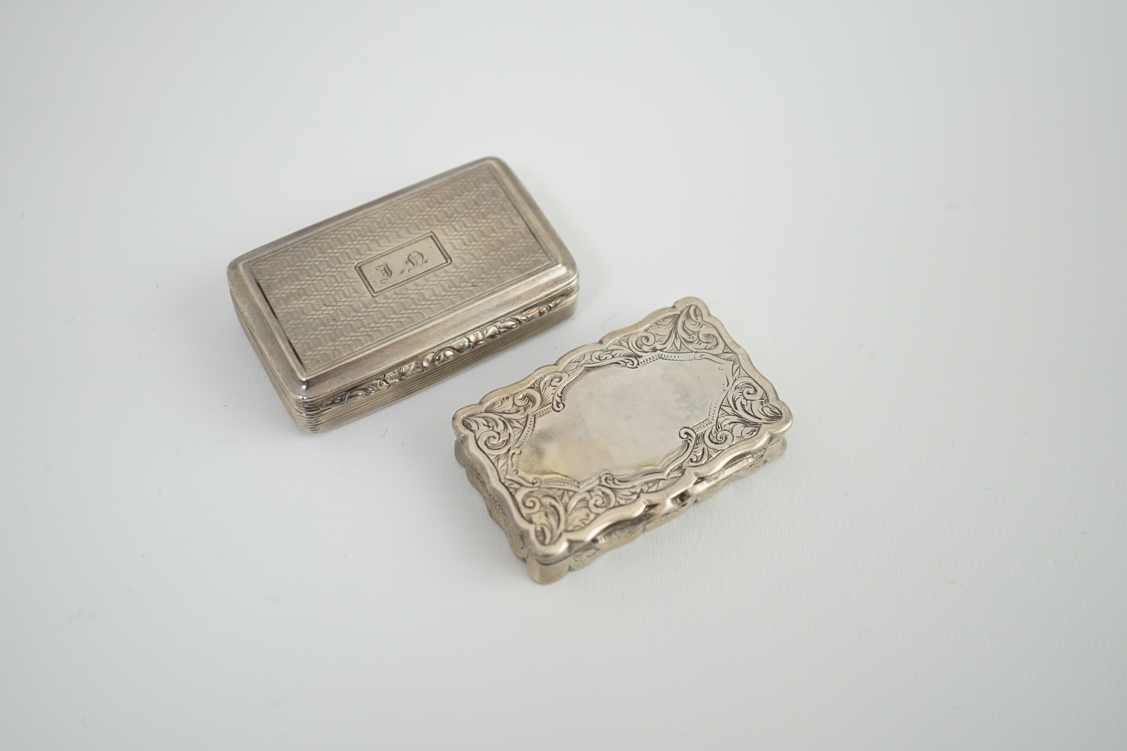 A George IV silver snuff box, with engraved initials, Thomas Shaw?, Birmingham, 1826, 54mm, together with a Victorian silver snuff box, George Unite, Birmingham, 1875.